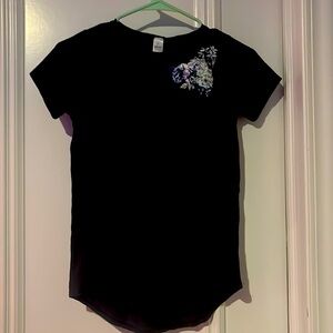 Ivivva black t shirt with flower design on the left shoulder.